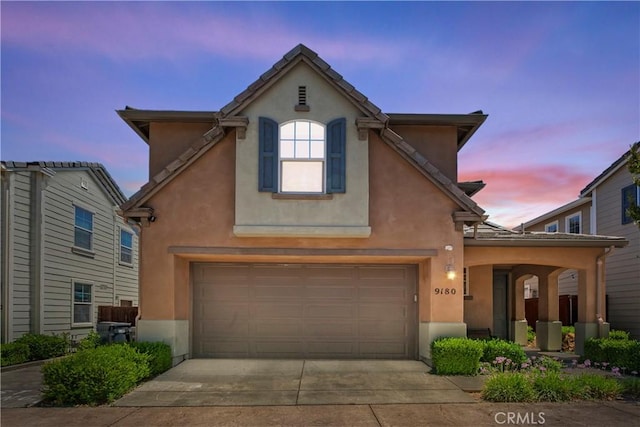9180 Araujo Ct, Atascadero, CA 93422 - view of front of house with a garage, stucco siding, and concrete driveway