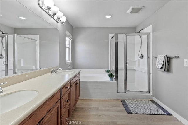9180 Araujo Ct, Atascadero, CA 93422 - full bathroom featuring a shower stall, a garden tub, double vanity, wood finished floors, and recessed lighting