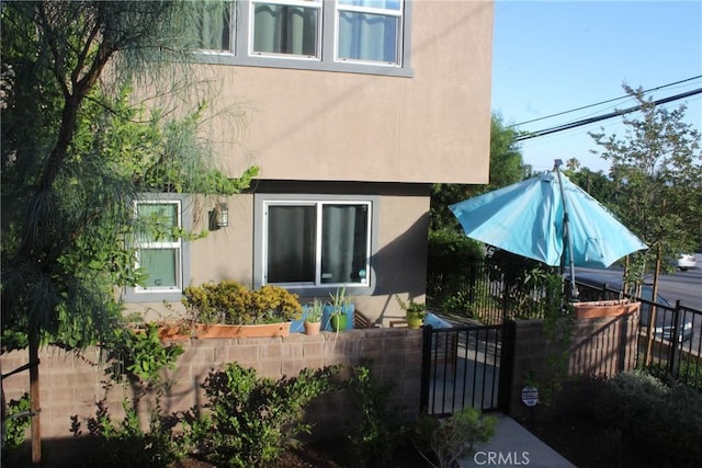 12801 N Watt Ln Unit A, Sylmar, CA 91342 - rear view of property featuring stucco siding and a gate