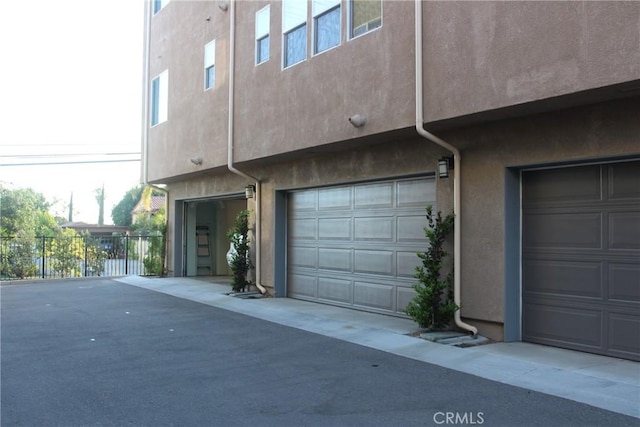 12801 N Watt Ln Unit A, Sylmar, CA 91342 - view of side of home featuring stucco siding and an attached garage