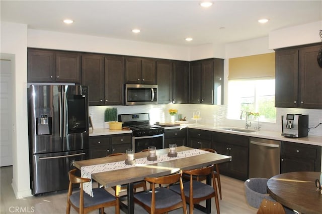 12801 N Watt Ln Unit A, Sylmar, CA 91342 - kitchen featuring appliances with stainless steel finishes, light wood-style floors, tasteful backsplash, and recessed lighting