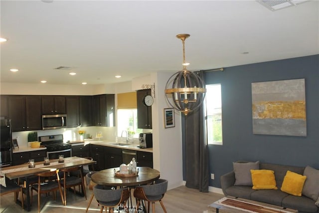 12801 N Watt Ln Unit A, Sylmar, CA 91342 - kitchen featuring stainless steel appliances, a chandelier, light countertops, light wood-style flooring, and recessed lighting