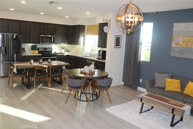 12801 N Watt Ln Unit A, Sylmar, CA 91342 - kitchen with stainless steel appliances, light wood finished floors, a chandelier, light countertops, and recessed lighting