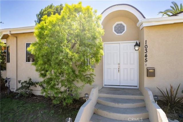 10345 Encino Ave, Granada Hills, CA 91344 - doorway to property with stucco siding