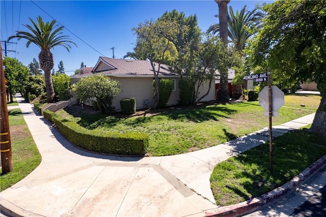10345 Encino Ave, Granada Hills, CA 91344 - view of property exterior with a lawn and stucco siding