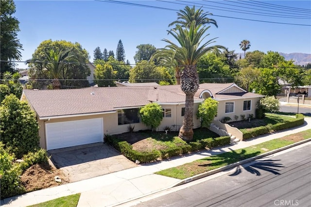 10345 Encino Ave, Granada Hills, CA 91344 - single story home with stucco siding, an attached garage, and driveway