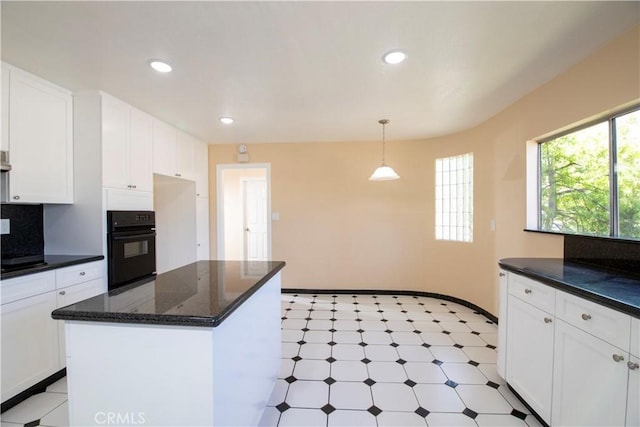 10345 Encino Ave, Granada Hills, CA 91344 - kitchen with oven, light flooring, white cabinetry, recessed lighting, and hanging light fixtures
