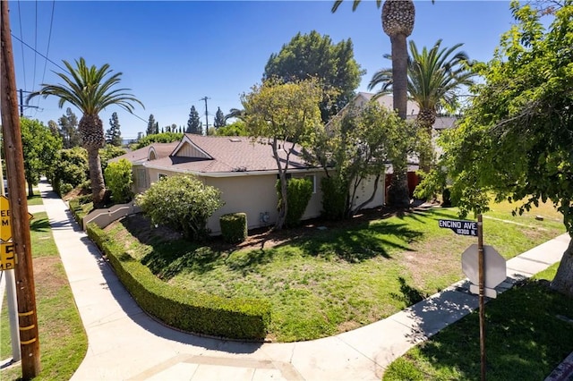 10345 Encino Ave, Granada Hills, CA 91344 - view of property exterior with a yard and stucco siding