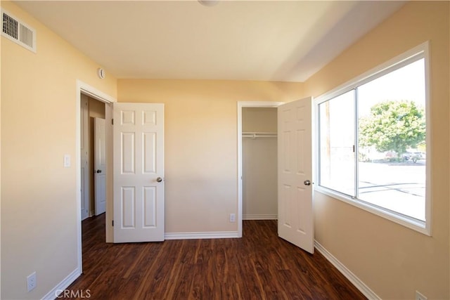 10345 Encino Ave, Granada Hills, CA 91344 - unfurnished bedroom featuring dark wood-style flooring and multiple windows