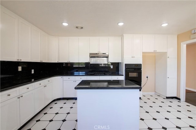 10345 Encino Ave, Granada Hills, CA 91344 - kitchen featuring oven, light floors, a center island, white cabinets, and recessed lighting