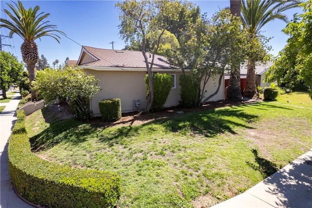 10345 Encino Ave, Granada Hills, CA 91344 - view of side of home with stucco siding and a yard