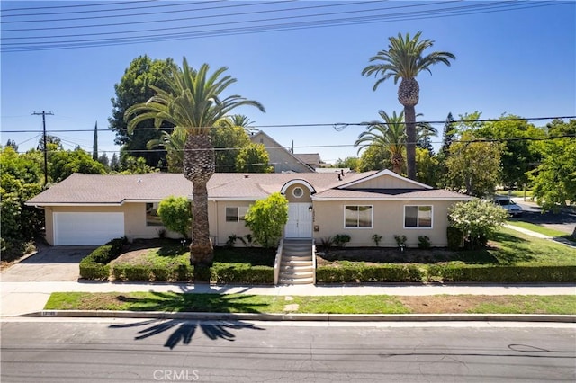 10345 Encino Ave, Granada Hills, CA 91344 - ranch-style house featuring concrete driveway, an attached garage, and stucco siding