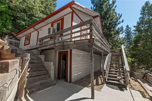 23034 Cedar Way, Crestline, CA 92325 - view of front of home with stairway, a garage, and a wooden deck