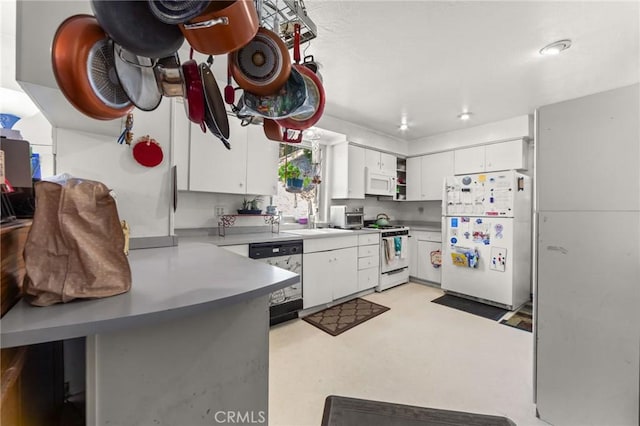 23034 Cedar Way, Crestline, CA 92325 - kitchen with white appliances, a peninsula, and white cabinetry