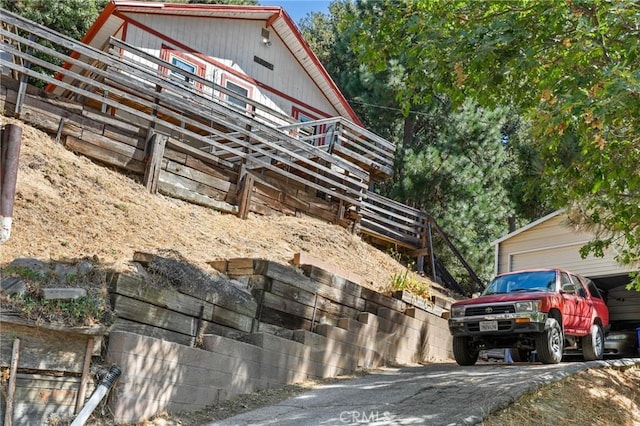 23034 Cedar Way, Crestline, CA 92325 - view of home's exterior featuring a garage and driveway