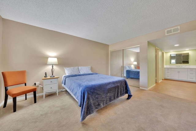 6820 Hyde Park Dr Unit A, San Diego, CA 92119 - bedroom featuring light colored carpet, a closet, ensuite bath, and a textured ceiling