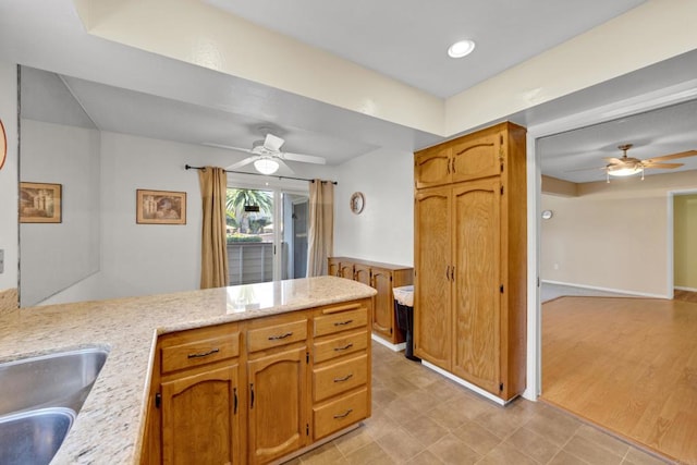 6820 Hyde Park Dr Unit A, San Diego, CA 92119 - kitchen with a ceiling fan, a peninsula, and brown cabinets