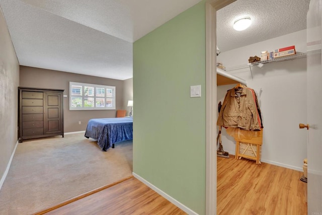 6820 Hyde Park Dr Unit A, San Diego, CA 92119 - bedroom with a textured ceiling and wood finished floors