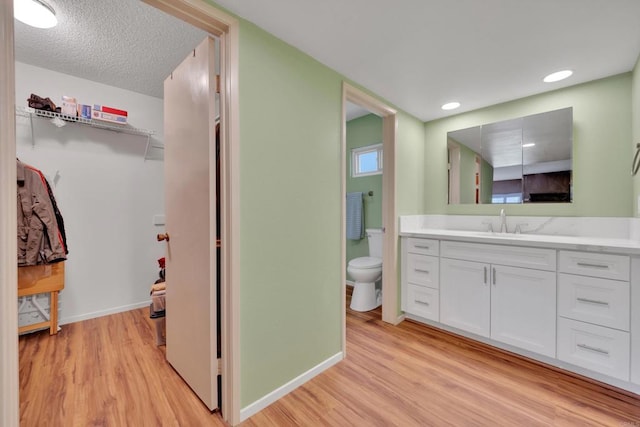 6820 Hyde Park Dr Unit A, San Diego, CA 92119 - bathroom with wood finished floors, vanity, and a walk in closet