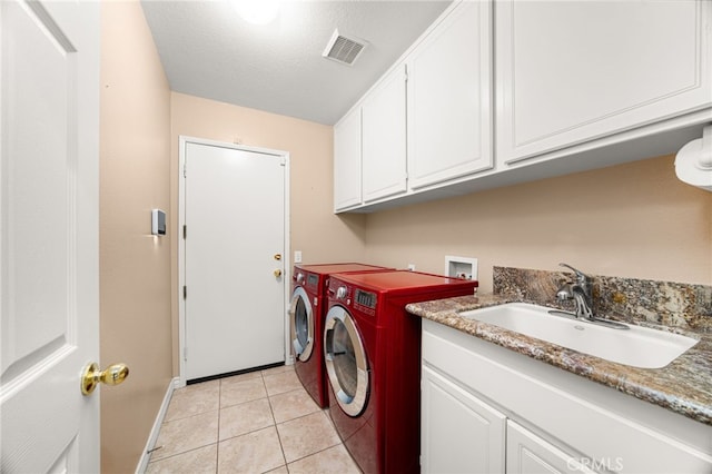 14067 Glendale Ct, Rancho Cucamonga, CA 91739 - washroom featuring cabinet space, separate washer and dryer, light tile patterned floors, and a textured ceiling