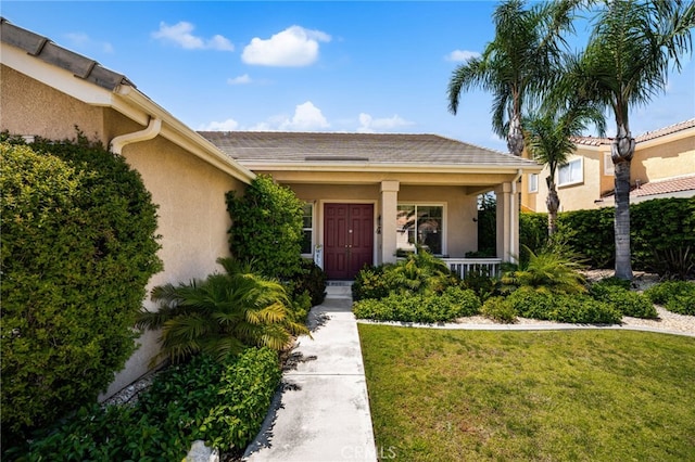 14067 Glendale Ct, Rancho Cucamonga, CA 91739 - property entrance featuring a lawn, covered porch, and stucco siding