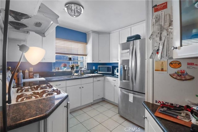 259 N Holliston Ave Unit 1, Pasadena, CA 91106 - kitchen featuring stainless steel appliances, dark countertops, light tile patterned flooring, and white cabinetry