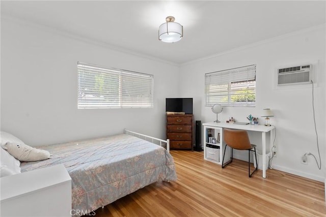 569 S Fenimore Ave, Covina, CA 91723 - bedroom with crown molding, a wall mounted AC, and light wood-type flooring