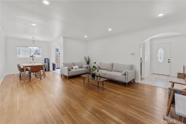 569 S Fenimore Ave, Covina, CA 91723 - living area with arched walkways, ornamental molding, light wood-style floors, and recessed lighting