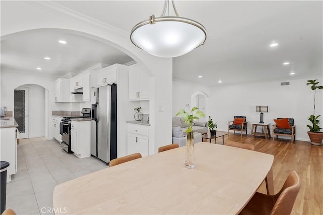 569 S Fenimore Ave, Covina, CA 91723 - dining room featuring arched walkways, recessed lighting, and ornamental molding