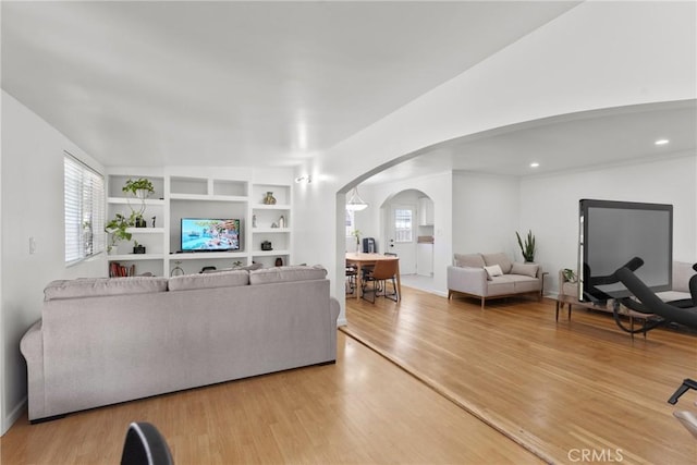 569 S Fenimore Ave, Covina, CA 91723 - living room with arched walkways, healthy amount of natural light, and wood finished floors
