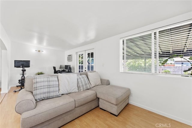 569 S Fenimore Ave, Covina, CA 91723 - living room featuring light wood-type flooring, french doors, and arched walkways
