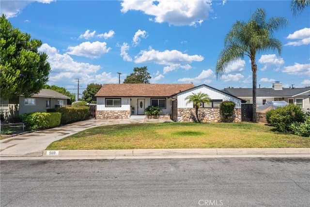 569 S Fenimore Ave, Covina, CA 91723 - view of front of property with stone siding, a front lawn, and driveway