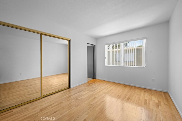 4320 Glencoe Ave Unit 2, Marina Del Rey, CA 90292 - unfurnished bedroom featuring multiple closets and wood finished floors