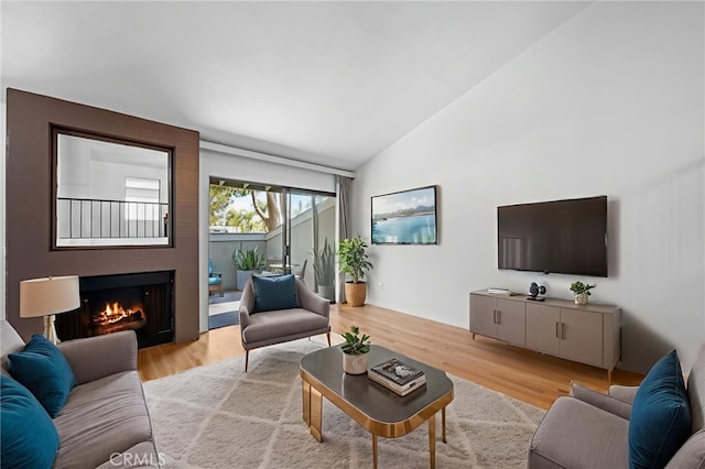 4320 Glencoe Ave Unit 2, Marina Del Rey, CA 90292 - living room with light wood-style flooring, a warm lit fireplace, and high vaulted ceiling