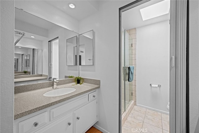 4320 Glencoe Ave Unit 2, Marina Del Rey, CA 90292 - full bathroom with vanity, a stall shower, a skylight, tile patterned floors, and recessed lighting