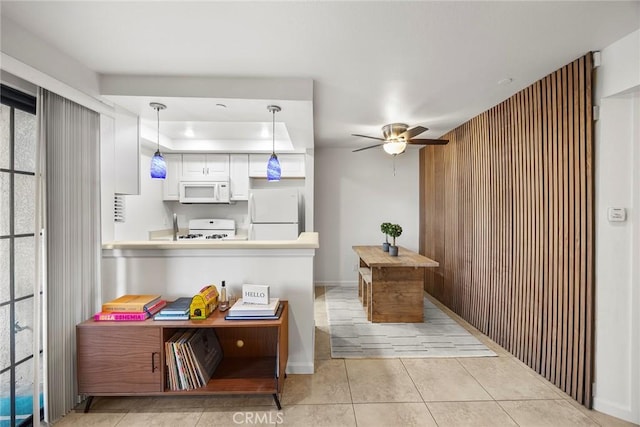 1068 Calle Del Cerro Unit 1521, San Clemente, CA 92672 - kitchen with white appliances, ceiling fan, white cabinetry, light tile patterned floors, and a peninsula