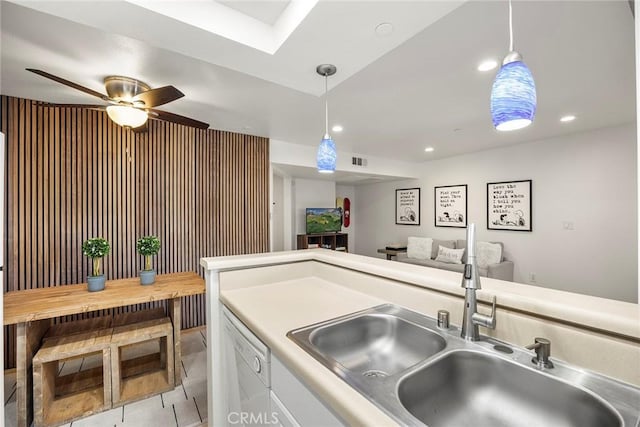 1068 Calle Del Cerro Unit 1521, San Clemente, CA 92672 - kitchen with white dishwasher, hanging light fixtures, open floor plan, a ceiling fan, and light countertops