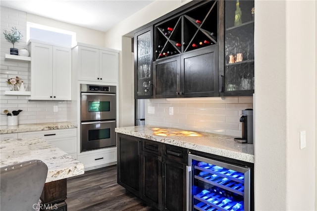 982 Camino Del Arroyo Dr Unit 49, San Marcos, CA 92078 - kitchen with open shelves, stainless steel double oven, wine cooler, backsplash, and white cabinets