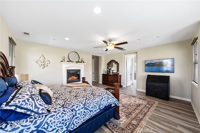 982 Camino Del Arroyo Dr Unit 49, San Marcos, CA 92078 - bedroom with wood finished floors, recessed lighting, a ceiling fan, and a glass covered fireplace