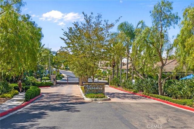 982 Camino Del Arroyo Dr Unit 49, San Marcos, CA 92078 - view of asphalt road featuring curbs, a gate, street lights, a gated entry, and sidewalks