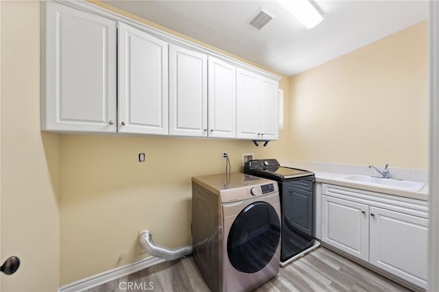 982 Camino Del Arroyo Dr Unit 49, San Marcos, CA 92078 - washroom with cabinet space, light wood-type flooring, and washer and dryer