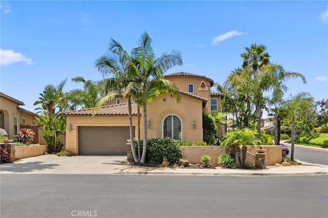 982 Camino Del Arroyo Dr Unit 49, San Marcos, CA 92078 - mediterranean / spanish-style home featuring stucco siding, a garage, driveway, and a tile roof