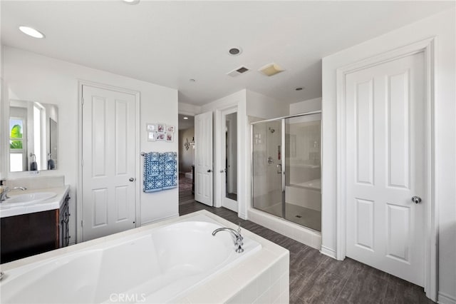 982 Camino Del Arroyo Dr Unit 49, San Marcos, CA 92078 - bathroom featuring vanity, a bath, a shower stall, wood finished floors, and recessed lighting
