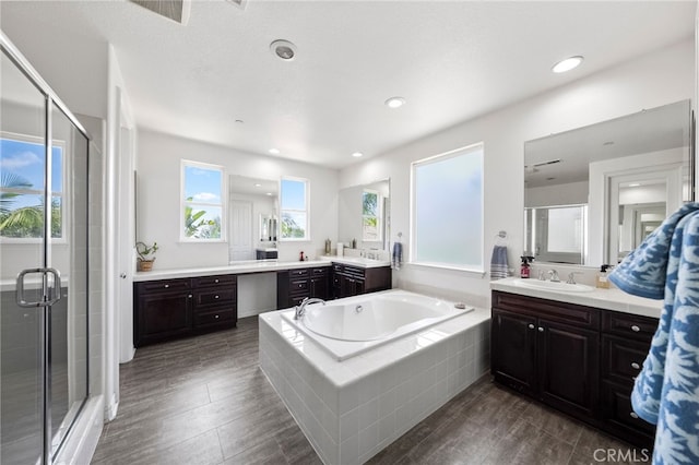 982 Camino Del Arroyo Dr Unit 49, San Marcos, CA 92078 - full bath featuring a stall shower, a garden tub, two vanities, wood finished floors, and recessed lighting