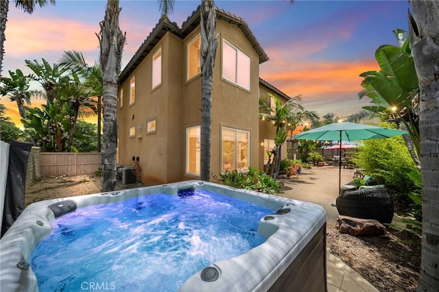 982 Camino Del Arroyo Dr Unit 49, San Marcos, CA 92078 - rear view of house featuring a hot tub, stucco siding, a fenced backyard, and a patio area