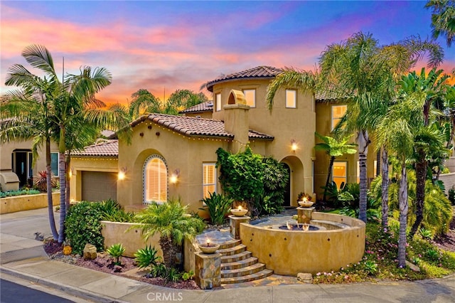 982 Camino Del Arroyo Dr Unit 49, San Marcos, CA 92078 - mediterranean / spanish-style home with a tile roof, stucco siding, an attached garage, and concrete driveway