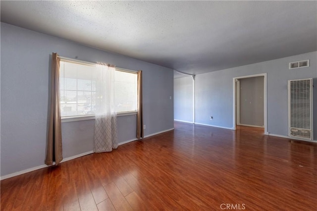 8933 Locust Ave, Fontana, CA 92335 - empty room featuring a heating unit and wood finished floors