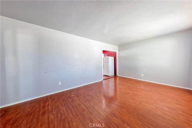 8933 Locust Ave, Fontana, CA 92335 - unfurnished room featuring wood finished floors and baseboards