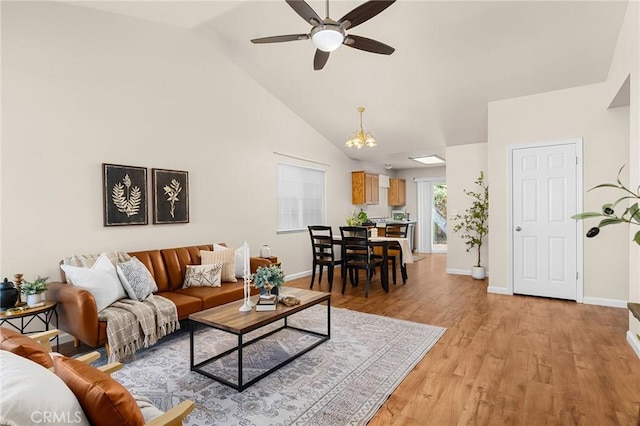 1057 Windsor Way, Chico, CA 95926 - living room with ceiling fan, light wood-style floors, high vaulted ceiling, and a chandelier