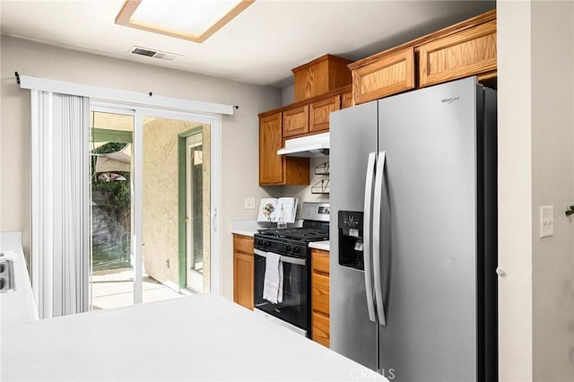 1057 Windsor Way, Chico, CA 95926 - kitchen with appliances with stainless steel finishes, under cabinet range hood, light countertops, and brown cabinetry